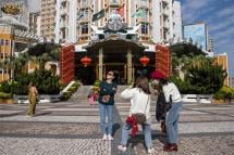 Mainland Chinese tourists walk past the Lisboa Casino in Macau, China, 22 January 2023. Photo: EPA