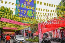 Commuters in the Maldives make their way along a street decorated ahead of the country's presidential election / Photo: AFP