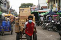 A worker wears a protective face masks as pushing a cart with goods at Sittwe market, Rakhine State, western Myanmar, 20 August 2020. Photo: Nyunt Win/EPA