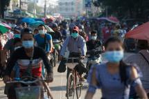  Commuters wearing face masks amid concerns over the spread of the COVID-19 coronavirus make their way on bikes in the Hlaing Tharyar township on the outskirts of Yangon on May 16, 2020. Photo: Sai Aung Main/AFP
