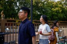 People wear cooling patches on their foreheads in Beijing, China, 17 June 2023. Photo: EPA