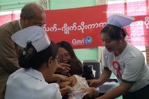 A nurse gives a vaccine shot to a child at Public Health Department in Magway Region. Photo: MNA
