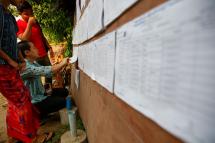 Myanmar women check the voters list as they arrive to cast their votes for by-elections at a polling station of Hlaing Thar Yar township in Yangon, Myanmar, 01 April 2017. Photo: Lynn Bo Bo/EPA