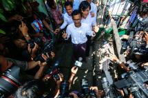 Journalists from Eleven media, editor in chief Kyaw Zaw Linn (C), managing editor Nari Min (C-R), and chief reporter Phyo Wai Win (C, back) talk to media in front of Tamwe township court after they were released on bail, Yangon, Myanmar, 26 October 2018. Photo: Lynn Bo Bo/EPA