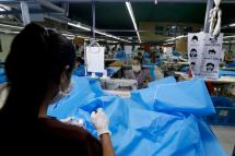 Workers make disposable surgical gown at a garment factory in Yangon, Myanmar. Photo: Nyein Chan Naing/EPA