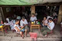 Myanmar people gather for refreshement at a teashop in Yangon on August 31, 2018 many hangout to chat and browse facebook with their mobile phone. Photo: Sai Aung Main/AFP