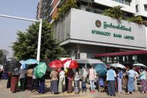 People queue outside the Myanmar military-owned Myawaddy Bank to withdraw their money as a form of protest against the military coup, in Yangon, Myanmar, 16 February 2021. Photo: EPA