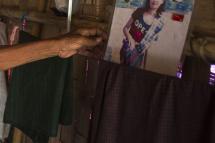 This photo taken on June 30, 2016 shows Mya Soe, 58, holding a photograph of his daughter Kyi Pyar Soe on the outskirts of Yangon. Enticed by work in China, hundreds of poor young Myanmar women are instead being duped into marriage, and left to scramble to get back across remote borders before they are forced into life with husbands they have never met. Photo: Ye Aung Thu/AFP
