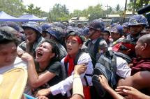 Student protesters and Buddhist monks jostle with police at barricades set up by police at the students protest site in Letpadan, Bago division, about 145 kilometres north of Yangon, Myanmar, 10 March 2015. Photo: Nyein Chan Naing/EPA
