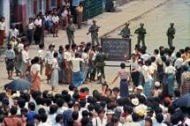 Troops order a crowd 26 August 1988 in downtown Rangoon (Yangon) to disperse in front of sule pagoda sealed off by barbed wires. Photo: AFP