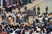 Troops order a crowd 26 August 1988 in downtown Rangoon (Yangon) to disperse in front of sule pagoda sealed off by barbed wires. Photo: AFP
