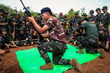 Members of the KNDF watching a demonstration on how to operate weapons during a training session for female special forces members and women battalions at their base camp in the forest near Demoso in Myanmar's eastern Kayah state. Photo: KNDF/AFP