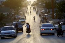 People drive and ride around a busy road at Myawaddy town, Karen State. Photo: Lynn Boo Bo/EPA