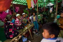 Internally displaced people wait in a temporary shelter in Danai, Kachin state. Photo: AFP
