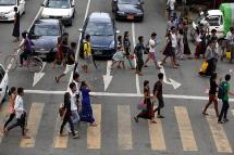 Prospects look good for Myanmar - People crossing a busy road in downtown Yangon. Photo: Nyein Chan Naing/EPA
