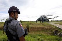Police stands guard near the military transport helicopter at Maungdaw township in Rakhine State, western Myanmar, 27 September 2017. Photo: Nyein Chan Naing/EPA
