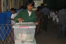 A young man casts his vote at a polling booth in Kyimyidine township, Yangon on 7 November, 2010. Photo: Mizzima
