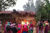 This screen grab made from AFPTV video footage taken on July 20, 2023, shows women burning the house of one of the men accused of parading two women naked in front of a mob during ongoing ethnic violence in India's northeastern Manipur state, in Nongpok Sekmai of Thoubal District some 32 Km from Manipur's capital Imphal.