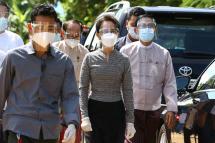 Myanmar's State Counsellor Aung San Suu Kyi (C), wearing protective gear amid the COVID-19 coronavirus pandemic, walks out after a visit to examine safety protocols for voting at an election commission district office in Naypyidaw on October 20, 2020, ahead of next month's election. Photo: Thet Aung/AFP