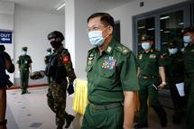 Myanmar military commander-in-chief Senior General Min Aung Hlaing (C), wearing a protective face mask, leaves after delivering a speech during a donation ceremony by Myanmar military for the ongoing pandemic of the coronavirus disease (COVID-19) in Yangon, Myanmar, 10 July 2020. Photo: Lynn Bo Bo/EPA