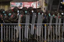 Soldiers stand guard on a street as tensions rise in Yangon, Myanmar, 25 February 2021. Photo: EPA