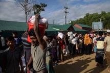 Rohingya refugees leave an aid relief distribution centre at the  Balukhali refugee camp near Cox's Bazar on August 12, 2018. Photo: Ed  Jones/AFP
