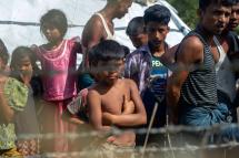 Rohingya refugees gather near the fence in the "no man's land" between Myanmar and Bangladesh border as seen from Maungdaw, Rakhine state, on June 29, 2018. Phyo Hein Kyaw/AFP

