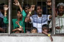 This picture taken on November 26, 2023 shows recently arrived Rohingya refugees looking on from their shared quarters at a temporary Indonesian immigration shelter in Lhokseumawe, Aceh province / Photo: AFP