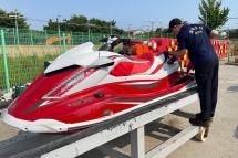 An undated handout photo made available by Korea Coast Guard shows two Coast Guard personel looking at a jet ski in Incheon, after the Coast Guard confirmed it had arrested a Chinese man who "attempted to smuggle into" the western port city of Incheon last week on the jet ski from China's Shandon. Photo: Korea Coast Guard/AFP