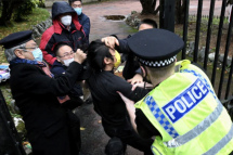 This handout from The Chaser News taken on October 16, 2022 and released to AFP on October 17 shows an incident involving a scuffle between a Hong Kong pro-democracy protester (C) and Chinese consulate staff, as a British police officer attempts to intervene, during a demonstration outside the consulate in Manchester. Photo: AFP