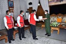 Senior General Min Aung Hlaing (r) presents medical supplies to a representative of Wa ethnic group at the headquarters of Golden Triangle Avenue of Triangle Region Command. Photo: MNA