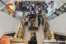 Customers buying clothes and shoes at a shopping mall in downtown Yangon. Photo: AFP