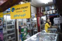 A signboard for mobile banking firm Wave Money at a telecommunications shop in downtown Yangon. Photo: AFP