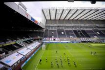 (File) Players warm up in front of empty stands prior to the English Premier League soccer match between Newcastle United and Liverpool FC in Newcastle, Britain, 26 July 2020. Photo: EPA