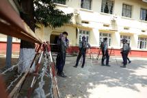 Armed police officers stand guard near Sittwe Court. Photo: Nyunt Win/EPA