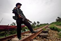 A Myanmar soldier stands guard on the rail track that between the Muslims area and Rakhine area near the Min Gan quarter in Sittwe, Rakhine State, western Myanmar. Photo: Lynn Bo Bo/EPA