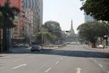 Taxi and bus in an empty street in downtown Yangon, Myanmar, 10 December 2021. Photo: EPA