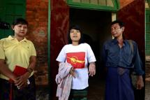 Student protester Ma Yi Mon Mon Aung (C) talks to media as her parents stand beside after she is released from Tharyarwaddy district administrative office in Bago division, Myanmar, March 12, 2015. Photo: Nyein Chan Naing/EPA
