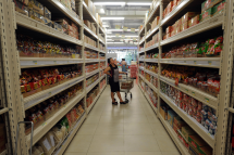 A woman looking at items displayed on shelves at a supermarket in downtown Yangon. Photo: AFP
