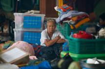 A old woman sits among piled up belongings of residents taking shelter inside a pagoda which is turned into a temporary evacuation center at Hpa-An Township in Kayin State, Myanmar, 02 August 2018. Photo: Lynn Bo Bo/EPA