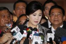Thailand's former prime minister Yingluck Shinawatra (C) speaks to members of the media as she arrives to answer questions to the National Legislative Assembly during impeachment proceedings against her at Parliament House in Bangkok, Thailand, January 22, 2015. Photo: Narong Sangnak/EPA
