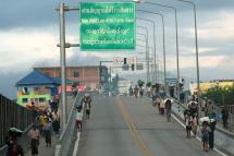 Myanmar nationals walk from Myanmar on their way to Thailand on the Thai-Myanmar Friendship Bridge at Myawaddy-Mae Sot. Photo: Narong Sangnak/EPA
