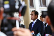 Thai Prime Minister Prayut Chan-o-cha (C) speaks to members of the media at Government House in Bangkok on 22 May, the anniversary of his military coup. Photo: Narong Sangnak/EPA  
