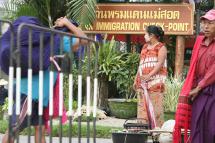 A woman standing in front of Tak immigration checkpoint in Mae Sot, Tak province in northern Thailand. Photo: EPA
