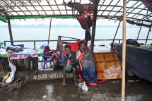 Local residents take shelter in Kyauktaw in Myanmar’s Rakhine state on May 14, 2023, as Cyclone Mocha's crashes ashore. Photo: AFP