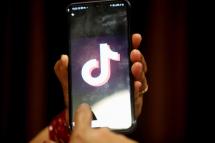 A woman opens the Chinese video-sharing app TikTok on her smartphone, in Bhopal, central India, 29 June 2020. Photo: EPA