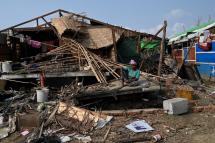 A Rohingya woman sits by her destroyed house at Ohn Taw Chay refugee camp in Sittwe on May 16, 2023, in the aftermath of Cyclone Mocha's landfall. Photo: AFP