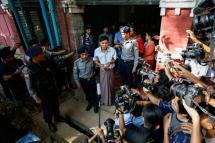 Detained Reuters journalist Kyaw Soe Oo (C) escorted by police as he talks to media after his trial at the court in Yangon, Myanmar, 22 May 2018. Photo: Lynn Bo Bo/EPA-EFE
