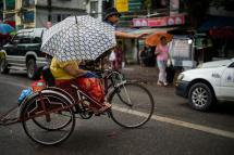 Trishaws are a regular aspect of Yangon city life. Photo: Roberto Schmidt/AFP

