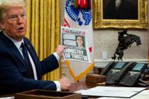 US President Donald J. Trump shows The New York Post paper as he makes remarks before signing an executive order on social media that will punish Facebook, Google and Twitter for the way they police content online, in the Oval Office, White House, Washington, DC, USA, 28 May 2020. Photo: EPA